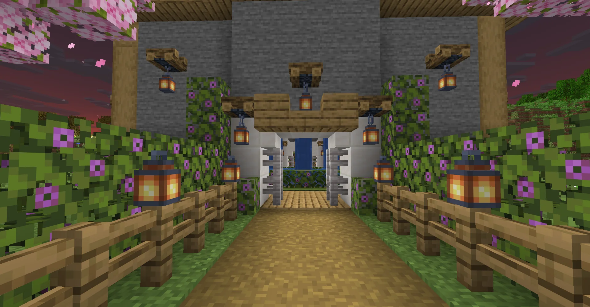 Flowering cherry leaves and lanterns along the path into CheesecakeMC's lobby